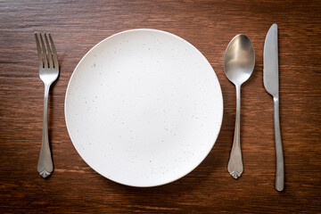 empty plate or dish with knife, fork and spoon