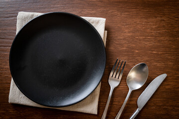 empty plate or dish with knife, fork and spoon