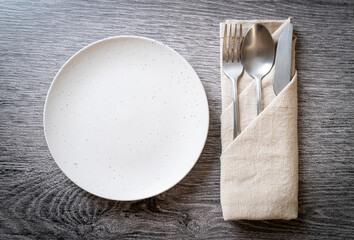 empty plate or dish with knife, fork and spoon