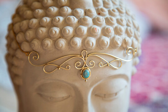 Brass tiara with gemstone on Buddha statue head