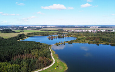 Top view of a beautiful city summer park with a lake and an embankment. 