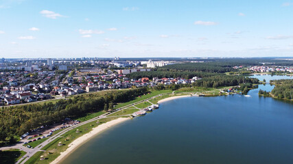 Fototapeta premium Top view of a beautiful city summer park with a lake and an embankment. 