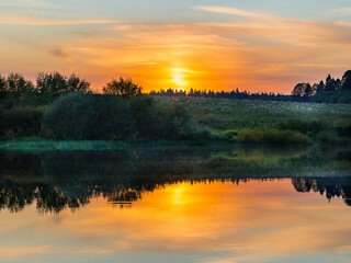 Autumn sunset on the lake while fishing from a boat