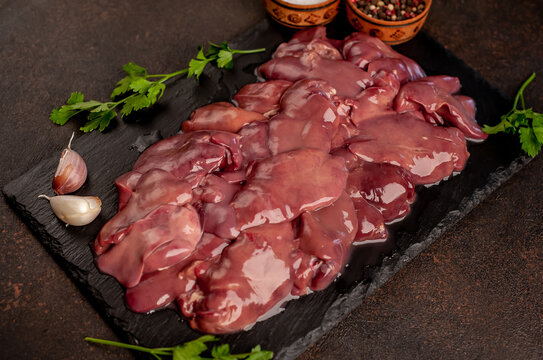 raw chicken liver on a stone background