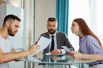 young caucasian couple visiting professional lawyer, refuse sign decree paper and finalize divorce....