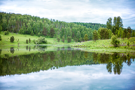 Beautiful summer landscape with reflection in the lake water