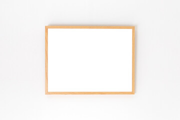 wooden picture frame on a white wall, mockup