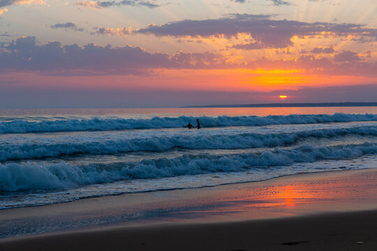 Image of summer sunny ocean waves and sunset in colorful tones