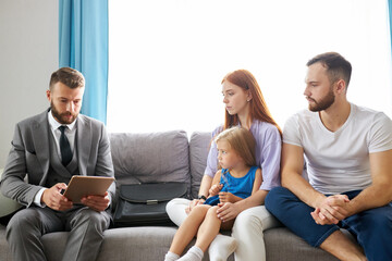 real estate agent came at home to married couple, they sit discussing possible getting of mortgage, sit on sofa at home