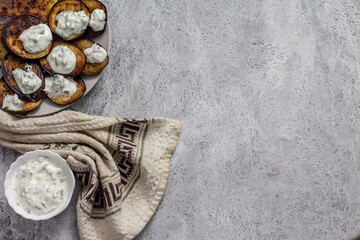 fried eggplants, cut into circles and served with sour cream sauce