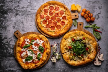 Pizza pattern. Three pieces set on grey concrete background. Top view, copyspace