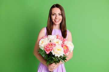 Portrait of her she nice attractive pretty lovely cheerful cheery girl enjoying holiday St Saint Patrick day holding in hands floral bunch isolated over green color background