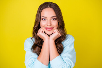Photo of lovely pretty charming young lady hands hold face smiling dream meet handsome guy imagine wedding ceremony wear blue sweater isolated vibrant yellow color background
