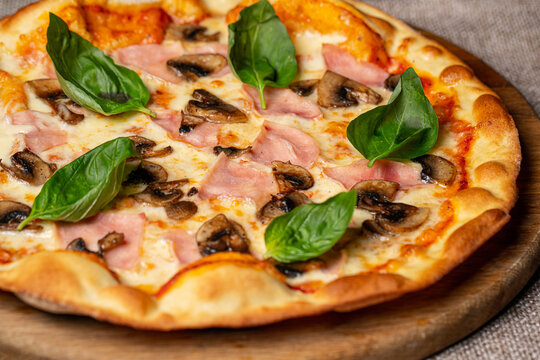 Pizza with mozzarella, tomato and basil leaves