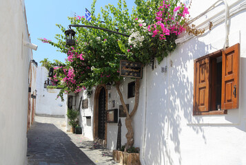 Lindos Greece street with bougainvillea against a white wall