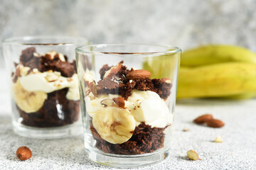 Banoffi pie in a glass on a concrete background.