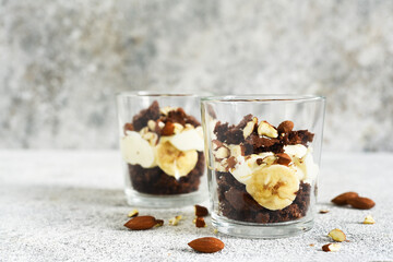 Banoffi pie in a glass on a concrete background.