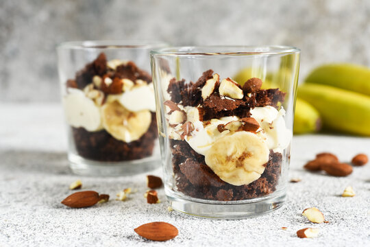 Banoffi pie in a glass on a concrete background.