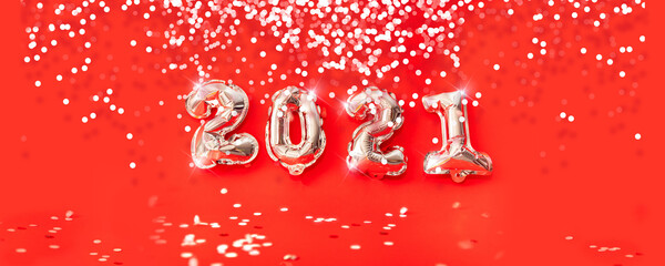 Happy new year 2021 celebration. gold foil balloons numeral 2021 isolated on red background