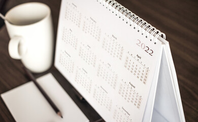 Calendar 2022 schedule with blank note for to do list on wooden desk