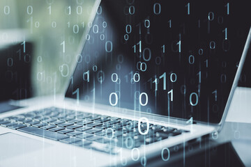 Creative concept of binary code illustration on modern laptop background. Big data and coding...