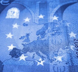 Shallow focus against euro banknote focused on europe map in blue tone