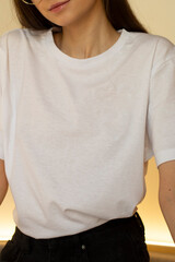 A young woman in a white t-shirt. For a clothing brand. Mock up.