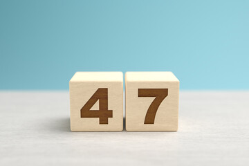 Wooden toy blocks forming the number 47.