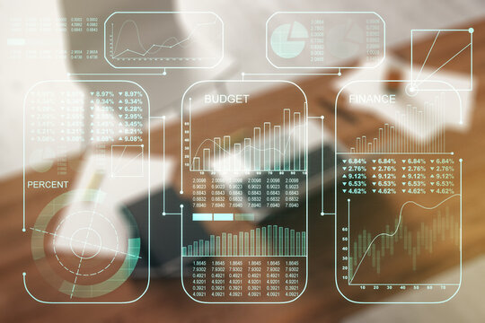 Double exposure of abstract creative statistics data hologram and modern desktop with laptop on background, statistics and analytics concept