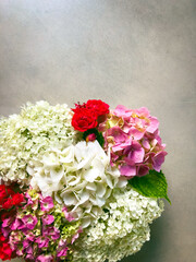 group of hydrangea flowers arrangement with small red roses