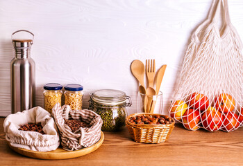 Variety of grains and legumes in glass jars and eco bags.