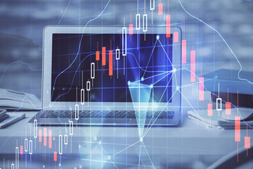 Financial market graph hologram and personal computer on background. Double exposure. Concept of forex.