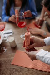 DIY wax candle making process. Woman making decorative wax candle, close-up of hands