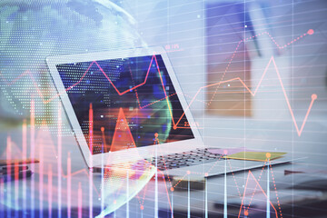 Stock market chart hologram drawn on personal computer background. Double exposure. Concept of investment.
