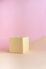 Abstract empty podium of geometric shape on pastel background for product. Beige cube on light brown and pink backdrop. Pedestal template for advertising photo. Minimal concept. Mock up.