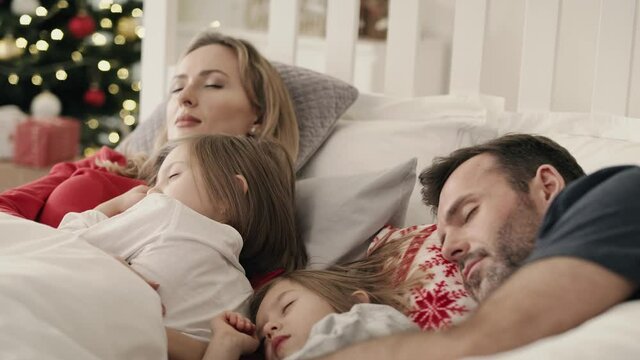 Video of family sleeping together in bed on Christmas morning.  Shot with RED helium camera in 8K.