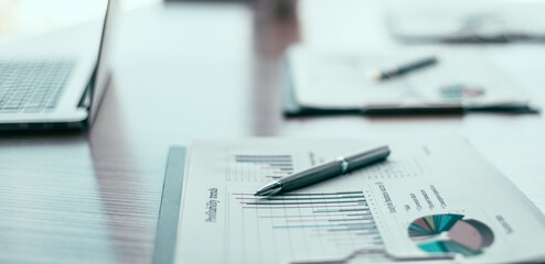 close up. financial chart and pen on the desktop.