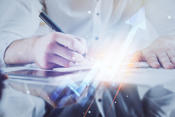 Businessman with creative business upward arrows on people hands background. Financial growth...