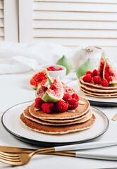Homemade classic american pancakes with almond, fresh raspberries and figs
