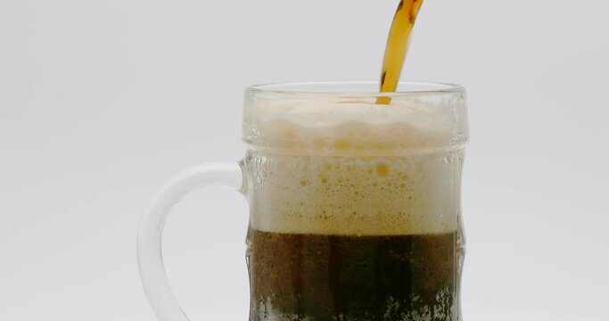 Beer Poured Into A Glass On A White Background