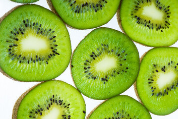Fototapeta premium Round slices of kiwi isolated on white background