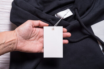 Hooded sweatshirt with paper, carton tab label