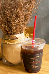 DIY & Interior décor concept of Decoration golden dried grass flower on blurred background at café restaurant or coffee shop with bright sunlight & sun rays from window wall, selective soft focus