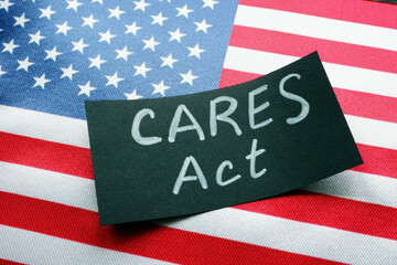 USA flag and word CARES act The Coronavirus Aid, Relief, and Economic Security Act.