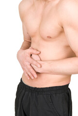 Naklejka premium A man with a naked torso holds his stomach on a white background