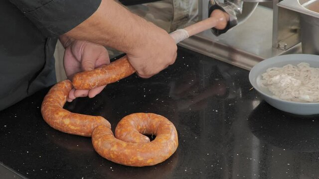 Using a sausage stuffer to make Hungarian sausage.
