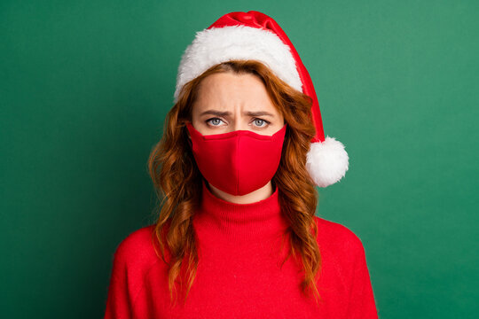 Photo of foxy upset young lady frustrated look wear red mask sweater x-mas cap isolated green color background