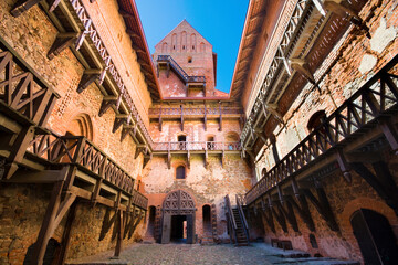 The inner yard of the Gothic style red brick Ducal Palace and its wooden stair galleries, Trakai,...