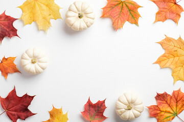 Autumn composition. Dried leaves and pumpkins on white background. Fall concept. Autumn background. Flat lay, top view, copy space
