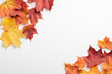 Autumn frame border of red and yellow maple leaves on white table. Autumn background. Fall, thanksgiving, harvest concept.